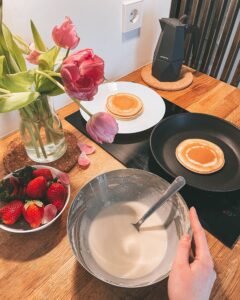Easy Strawberry Pancakes with Honey Homemade strawberry pancake cooking in a skillet