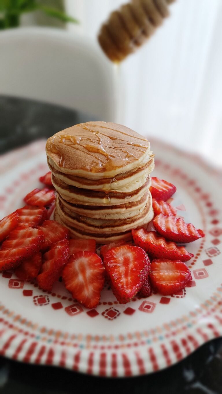 Easy Strawberry Pancakes with Honey topped with fresh strawberries
