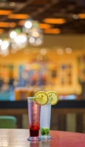 Best Blue Lagoon Mojito Mocktail Recipe: A Refreshing Drink for Any Occasion Pink citrus mocktail with lemon slice and mint in a tall glass