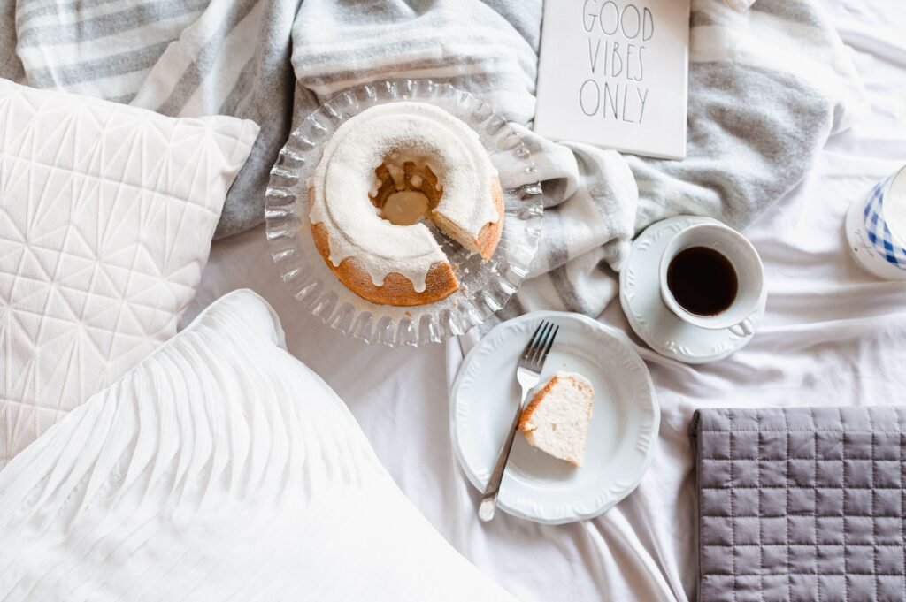 Vanilla breakfast bundt cake with a sliced piece and cup of coffee
