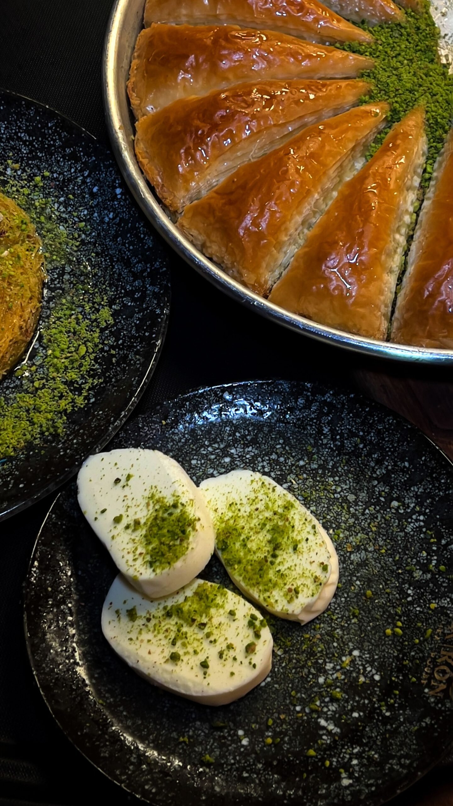 Pistachio Baklava: A Crisp, Buttery Dessert Made for Sharing Pistachio baklava slices with glossy golden pastry layers served beside pistachio-topped ice cream.