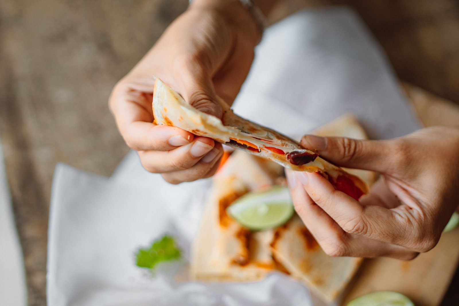 Easy Breakfast Quesadilla Recipe for a Quick Morning Meal Breakfast quesadilla being pulled apart with melted cheese and colorful vegetable filling
