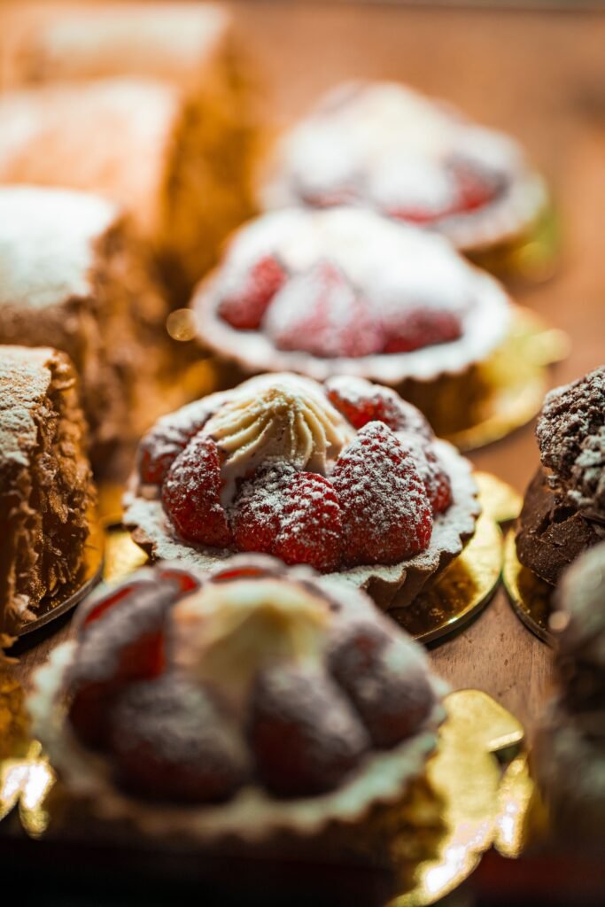 Fresh strawberry tartlets with whipped cream in a bakery display